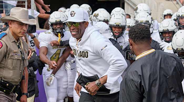 Deion Sanders leading Colorado out.